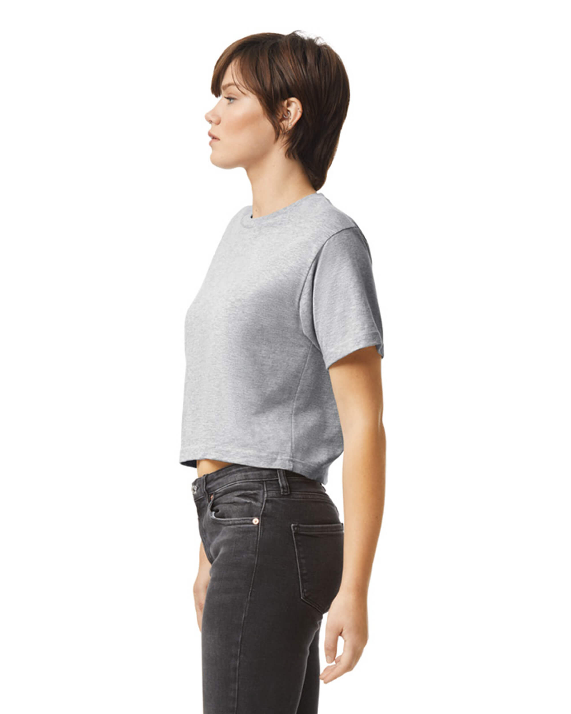 Female model wearing an American Apparel Fine Jersey Women's Boxy Tee in Heather Sport Grey, paired with black jeans, standing against a plain background (front pose) -heather sport grey