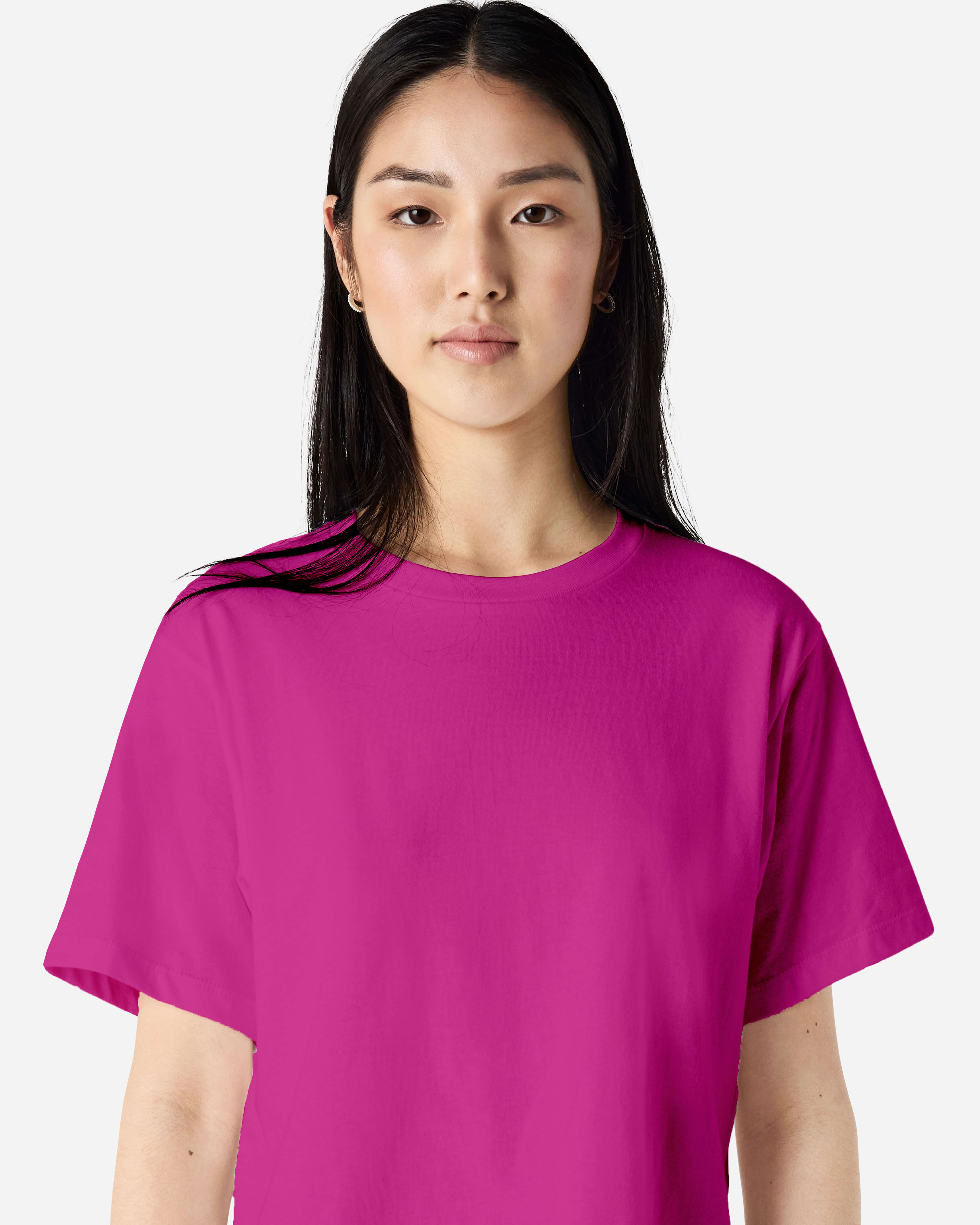 Female model wearing an American Apparel Fine Jersey Women's Boxy Tee in Super Pink, paired with blue jeans, standing against a plain background (front pose) -super pink