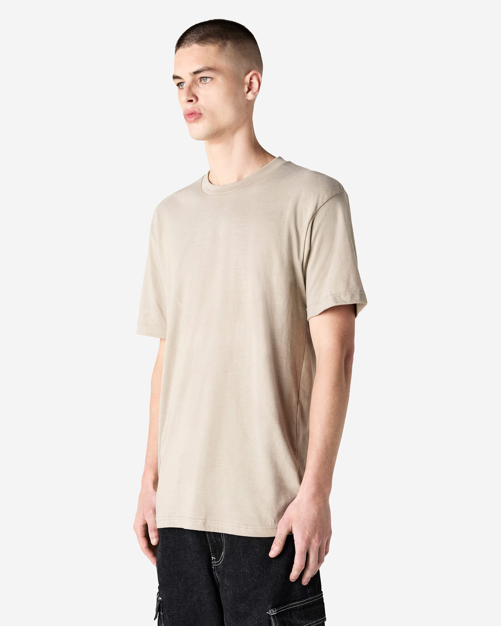 Male model wearing heather bone colour CVC Unisex Short Sleeve Crew Neck Tee (side pose) -heather bone