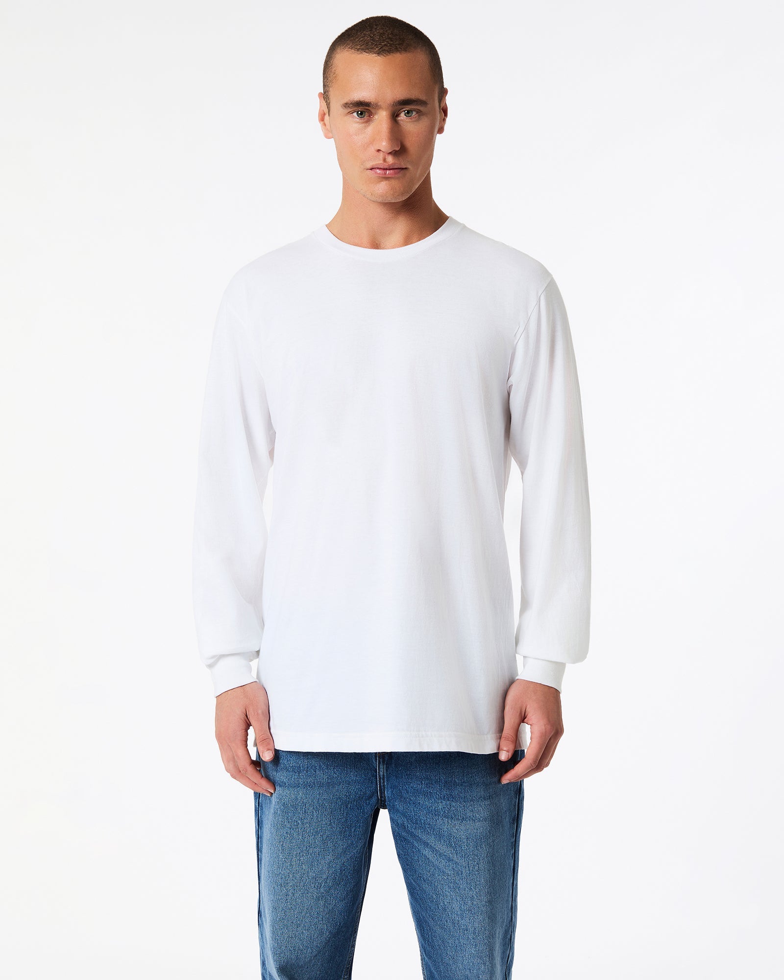 male model wearing American Apparel white Colour Fine Jersey Unisex Long Sleeve Crew Neck T-shirt- Front pose