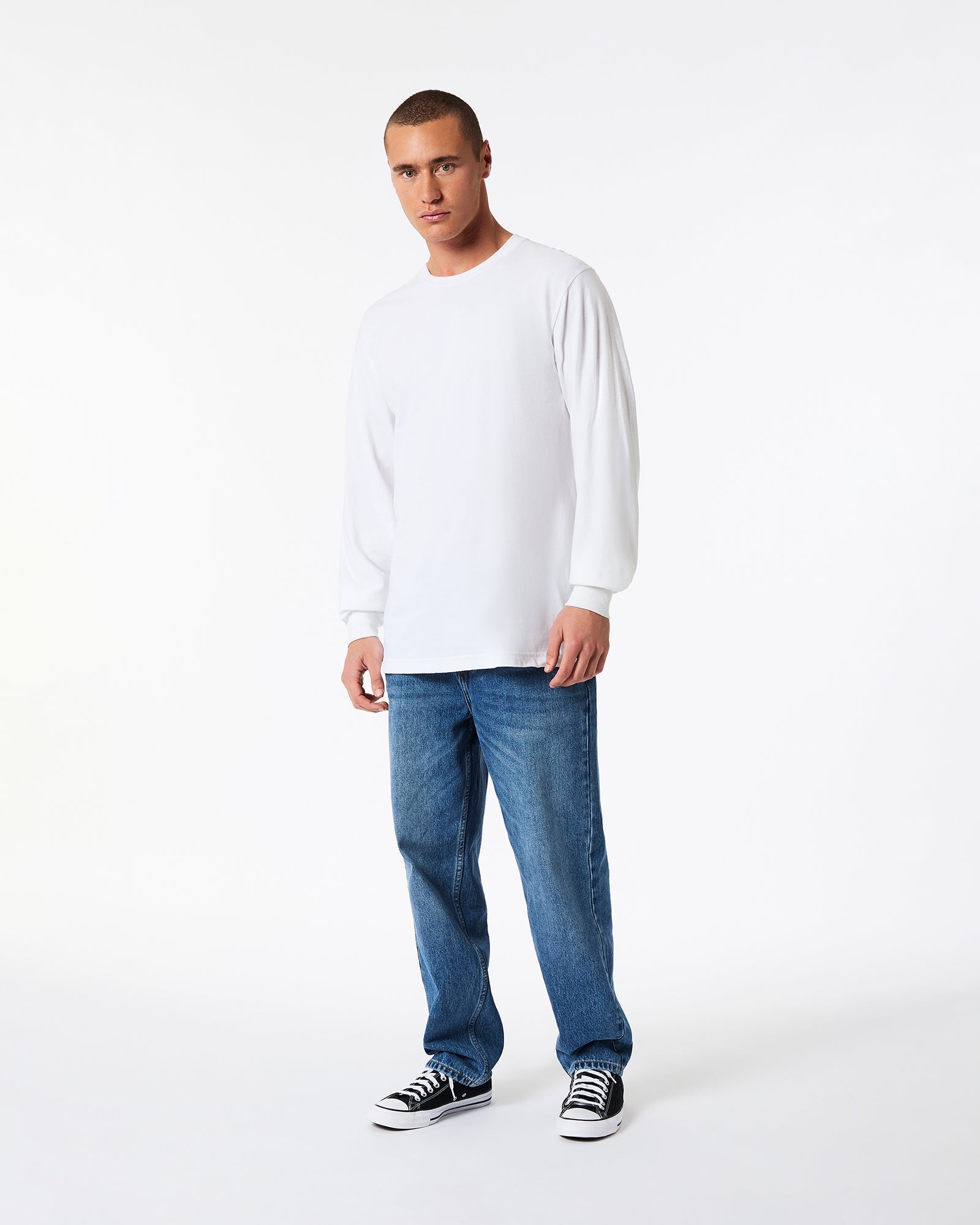 A male model wearing American Apparel white Colour Fine Jersey Unisex Long Sleeve Crew Neck T-shirt- Front pose