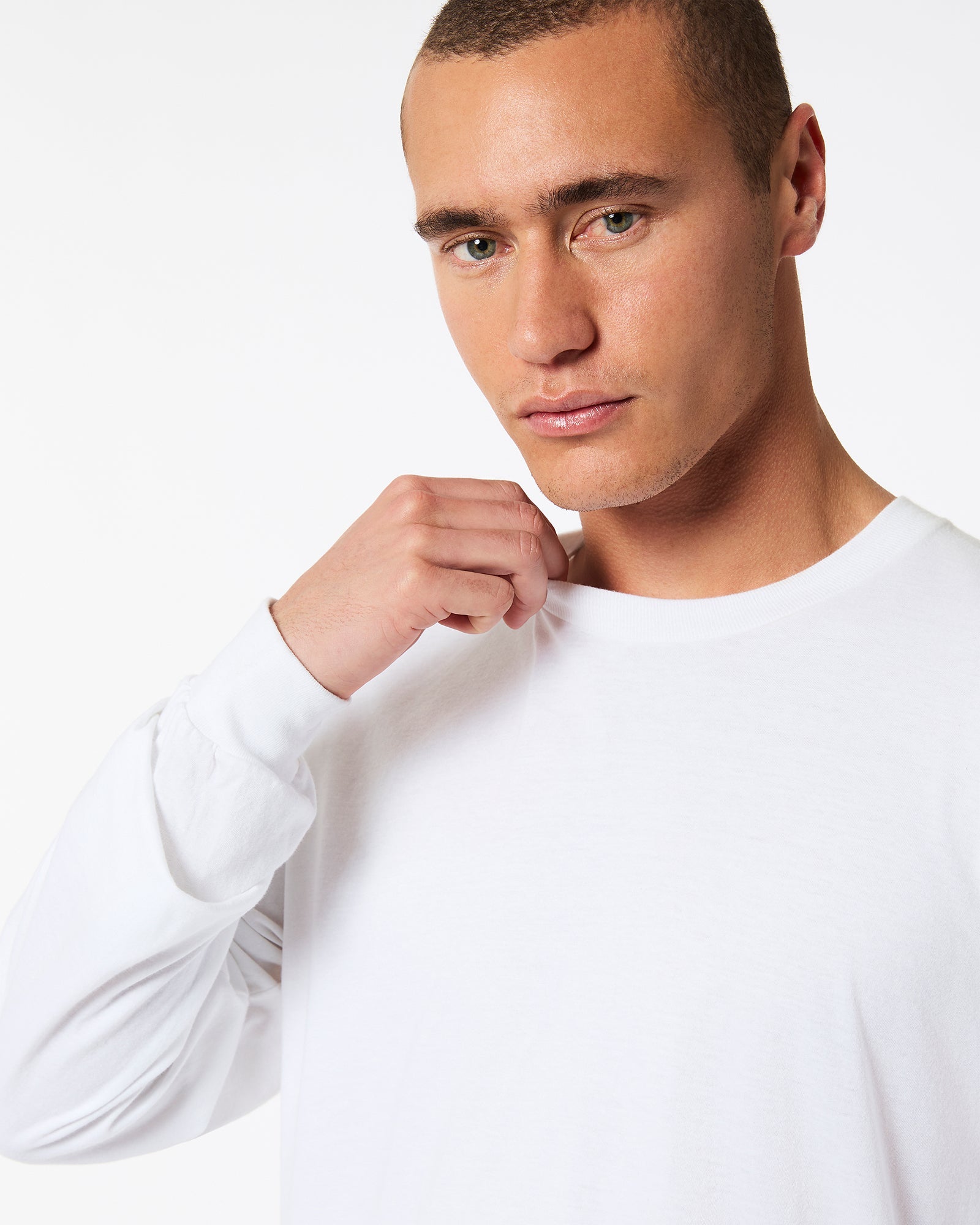 male model wearing American Apparel white Colour Fine Jersey Unisex Long Sleeve Crew Neck T-shirt- half Front pose