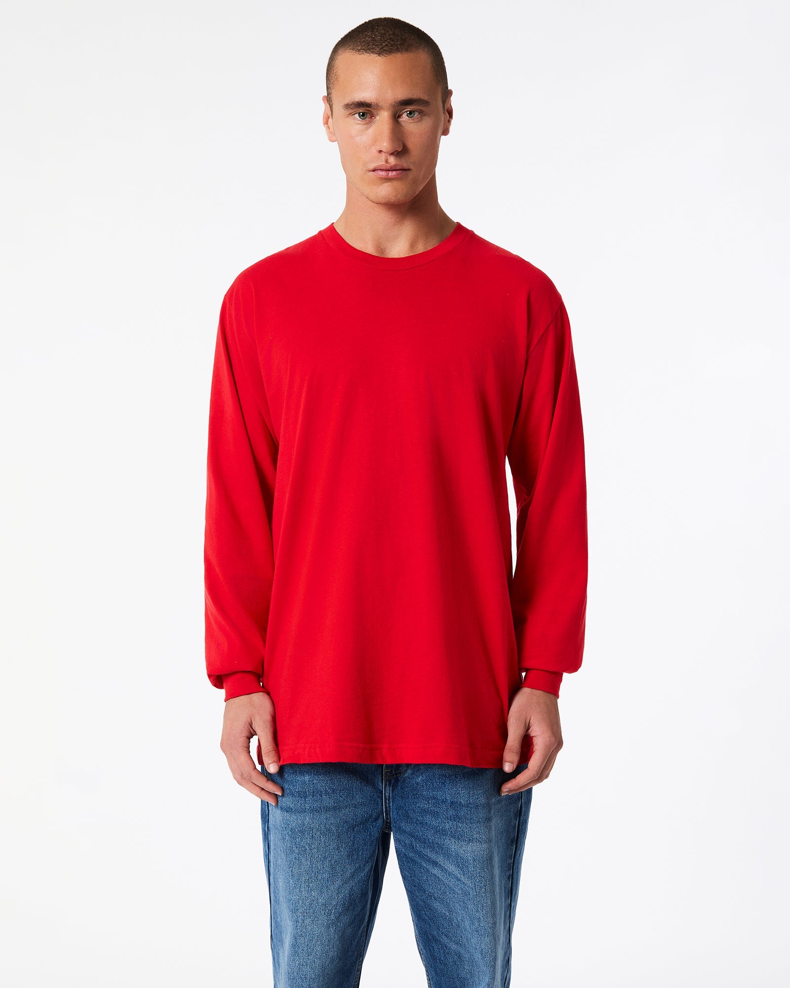 male model wearing American Apparel Red Colour Fine Jersey Unisex Long Sleeve Crew Neck T-shirt- Front pose