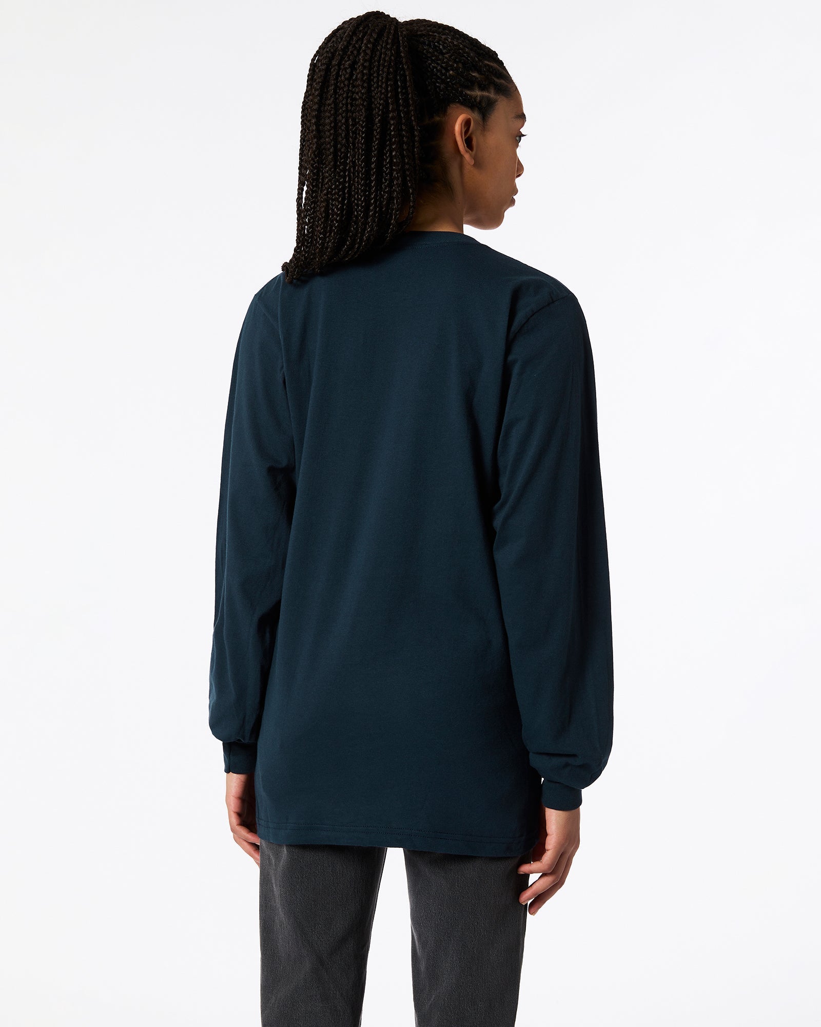 Female model wearing American Apparel Navy Colour Fine Jersey Unisex Long Sleeve Crew Neck T-shirt- back pose