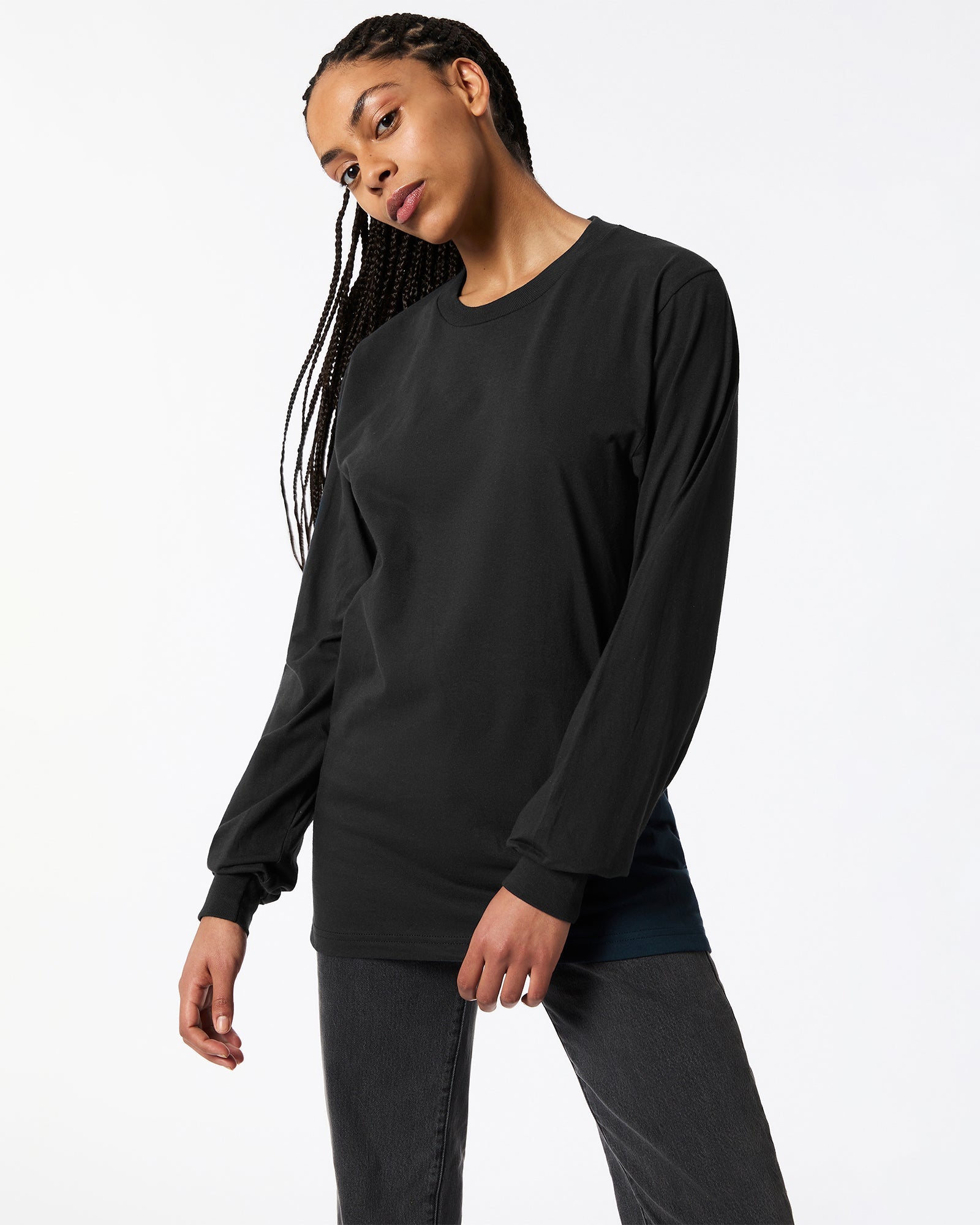 Female model posing while wearing Black Colour Fine Jersey Unisex Long Sleeve Crew Neck T-shirt- Front pose