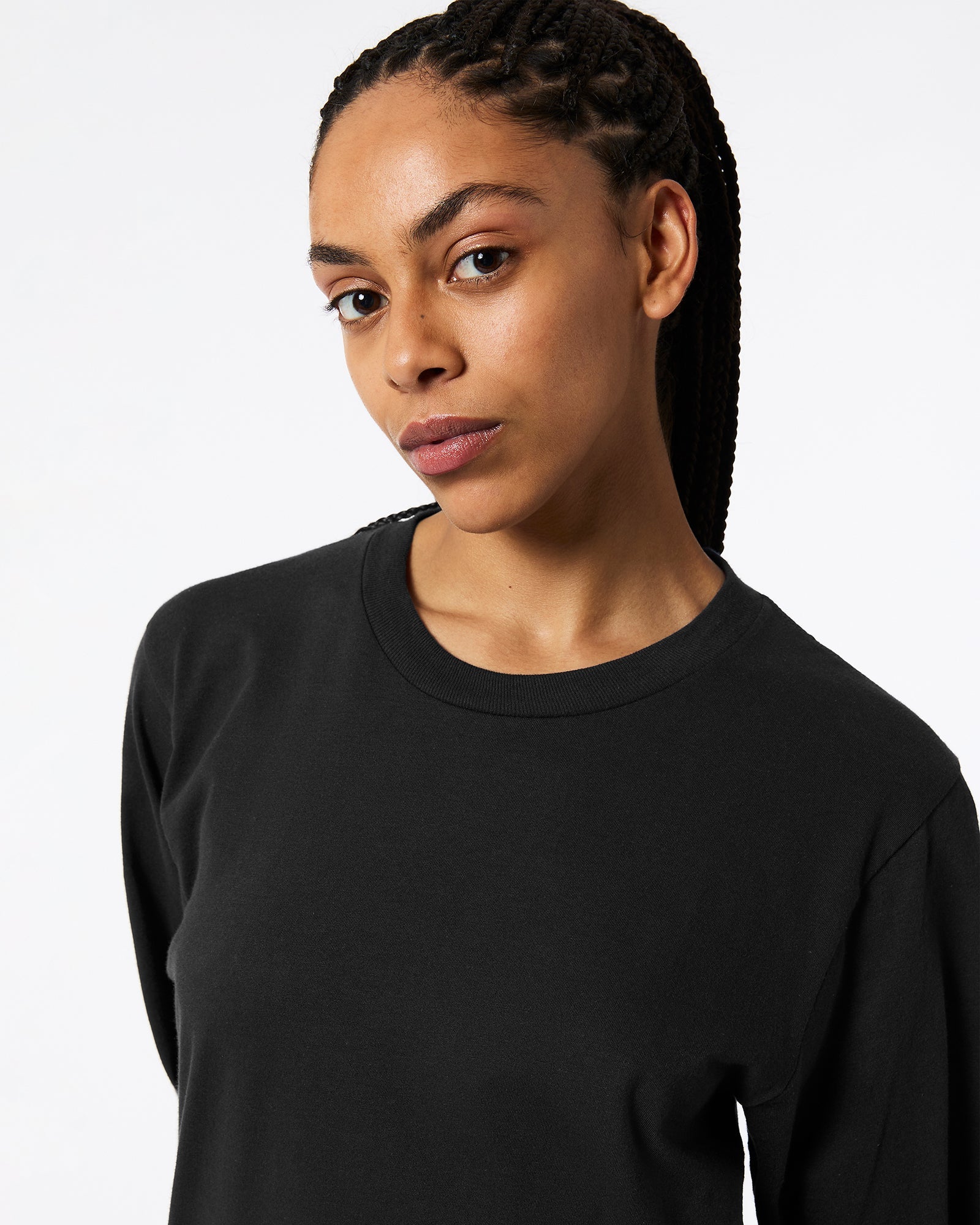 Female model wearing Black Colour Fine Jersey Unisex Long Sleeve Crew Neck T-shirt- half Front pose