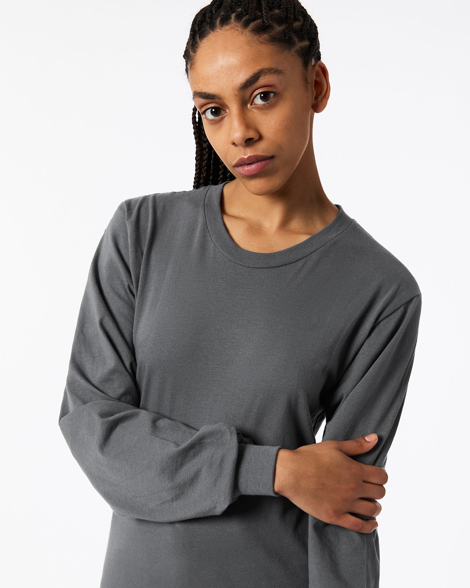 Female model wearing Asphalt Colour Fine Jersey Unisex Long Sleeve Crew Neck T-shirt- hand on elbow pose