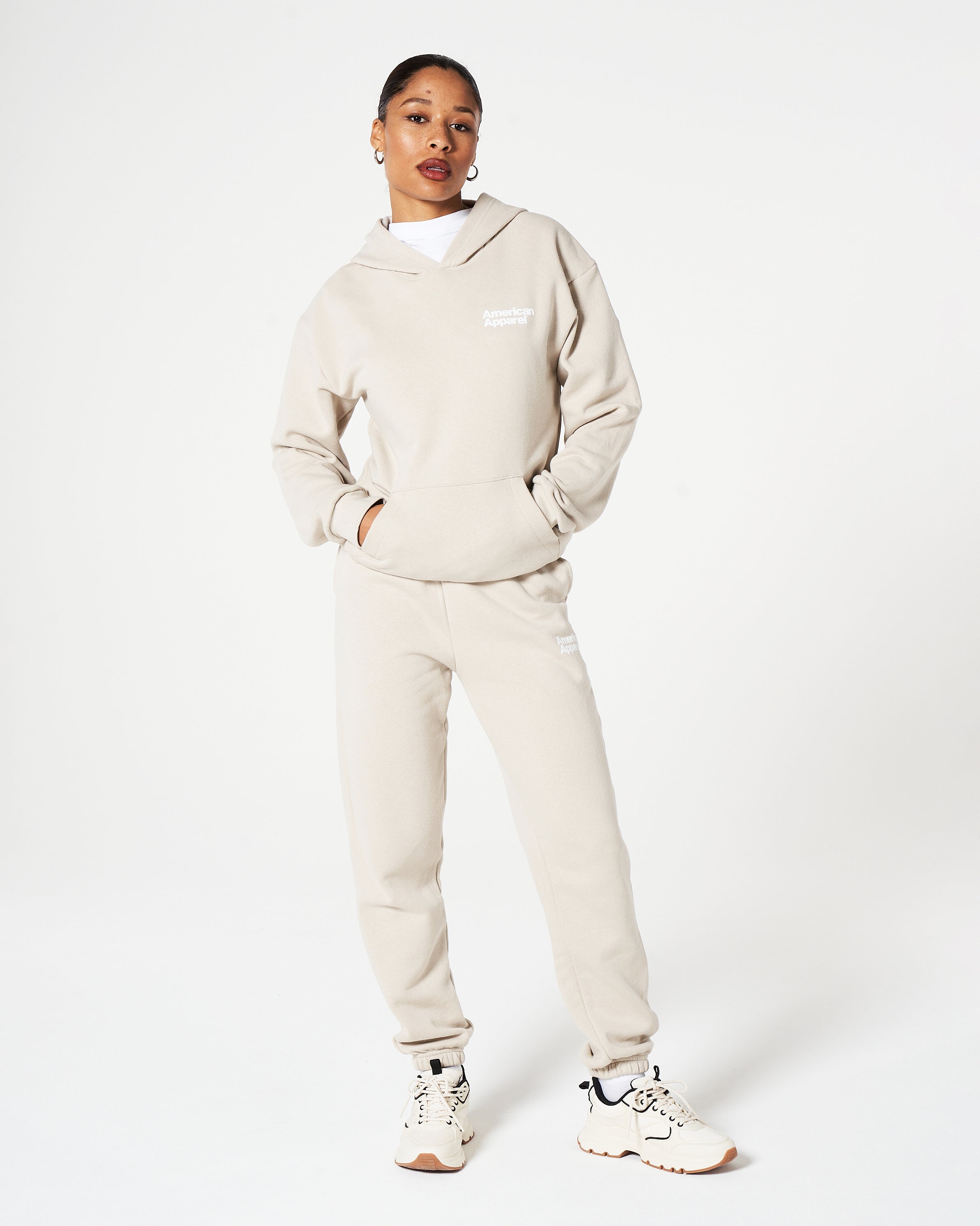 Female model wearing Bone American Apparel Pocket Puff Print Logo Tracksuit Set -bone