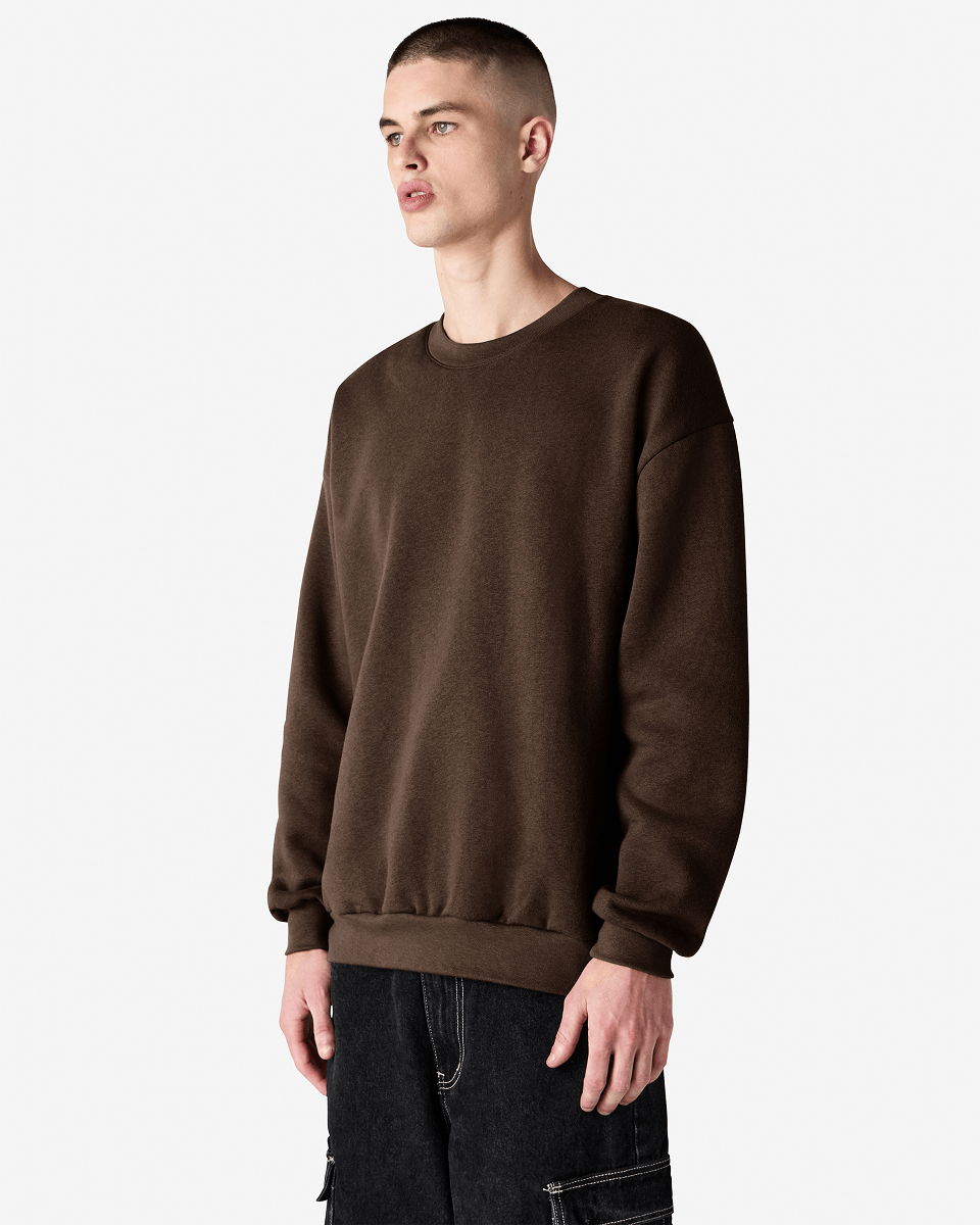 Male model wearing a Reflex Unisex Crewneck Sweatshirt (side pose) -brown